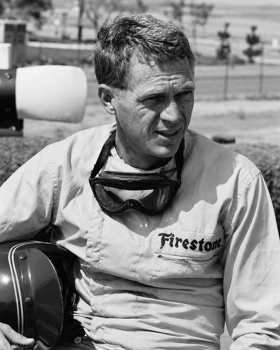 Steve McQueen with riding goggles and a helmet.